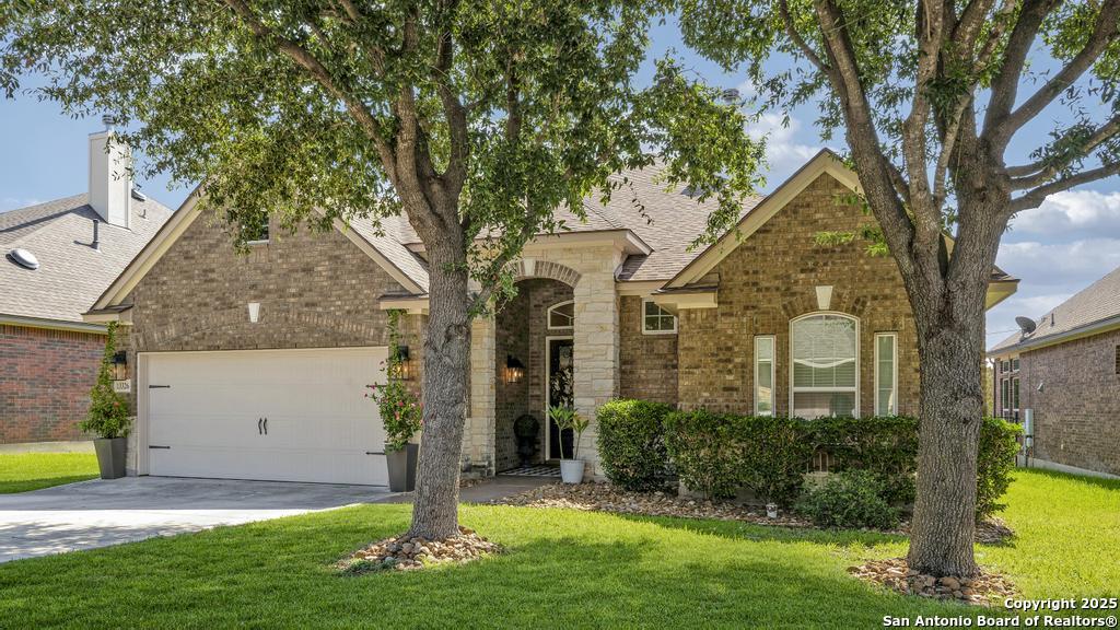 13326 Windmill Trace Helotes, TX 78023 - Photo 34 of 34 a front view of a house with garden
