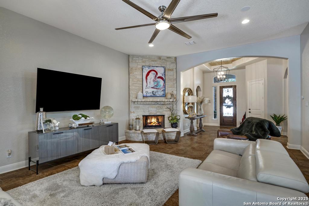 13326 Windmill Trace Helotes, TX 78023 - Photo 6 of 34 a living room with fireplace furniture and a flat screen tv