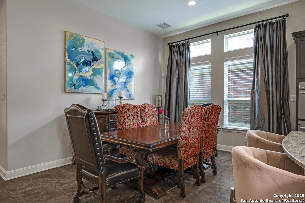 13326 Windmill Trace Helotes, TX 78023 - Photo 9 of 34 a dining room with furniture and window