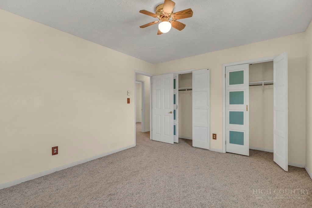 163 Rolling Hill Drive Boone, NC 28607 - Photo 18 of 40 a view of a big room with chandelier fan and windows