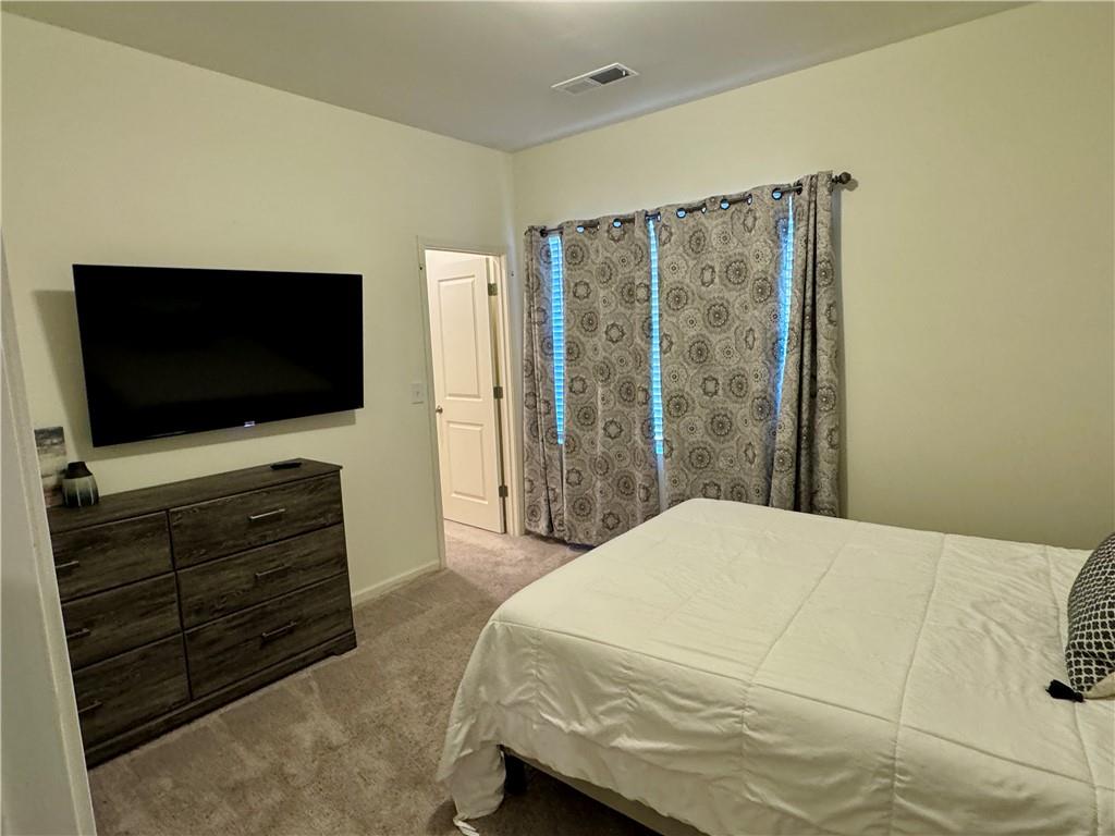 152 Andria Way Northwest Cartersville, GA 30120 - Photo 13 of 24 a bedroom with a bed and a flat screen tv