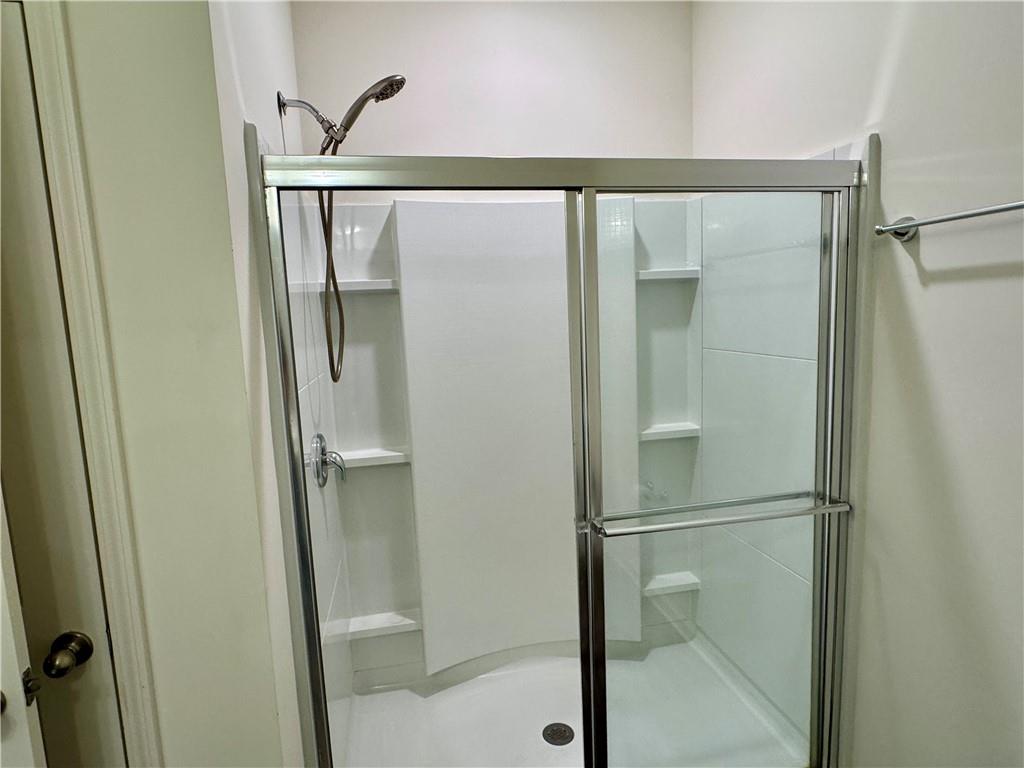 152 Andria Way Northwest Cartersville, GA 30120 - Photo 20 of 24 a bathroom with a glass shower door and mirror