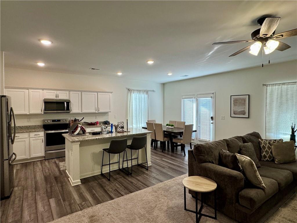 152 Andria Way Northwest Cartersville, GA 30120 - Photo 7 of 24 a living room with stainless steel appliances kitchen island furniture a kitchen view and a wooden floor