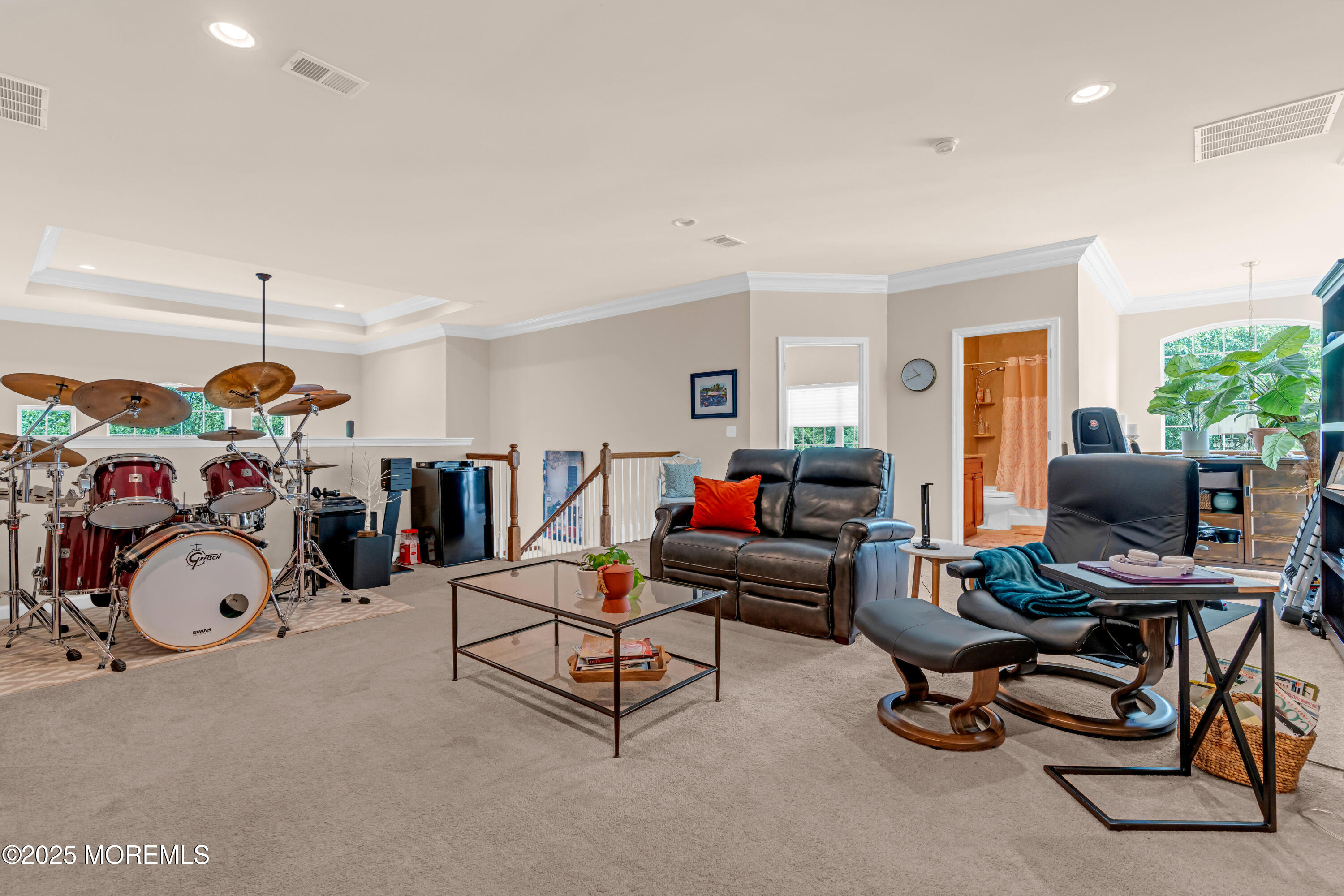 37 Abbey Road Tinton Falls, NJ 07753 - Photo 11 of 18 a living room with lots of furniture and a gym machine