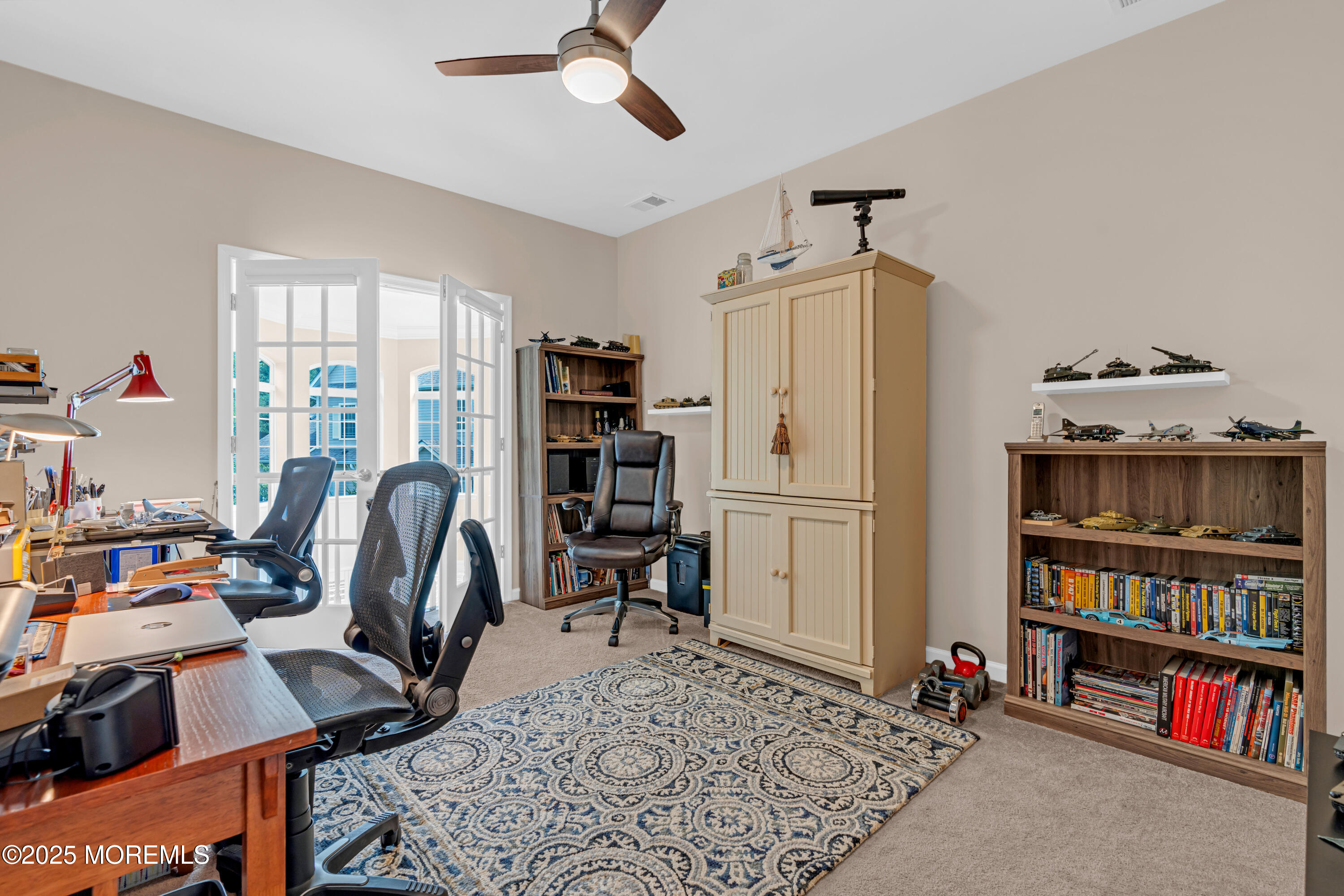 37 Abbey Road Tinton Falls, NJ 07753 - Photo 12 of 18 a view of a workspace with furniture and a bookshelf