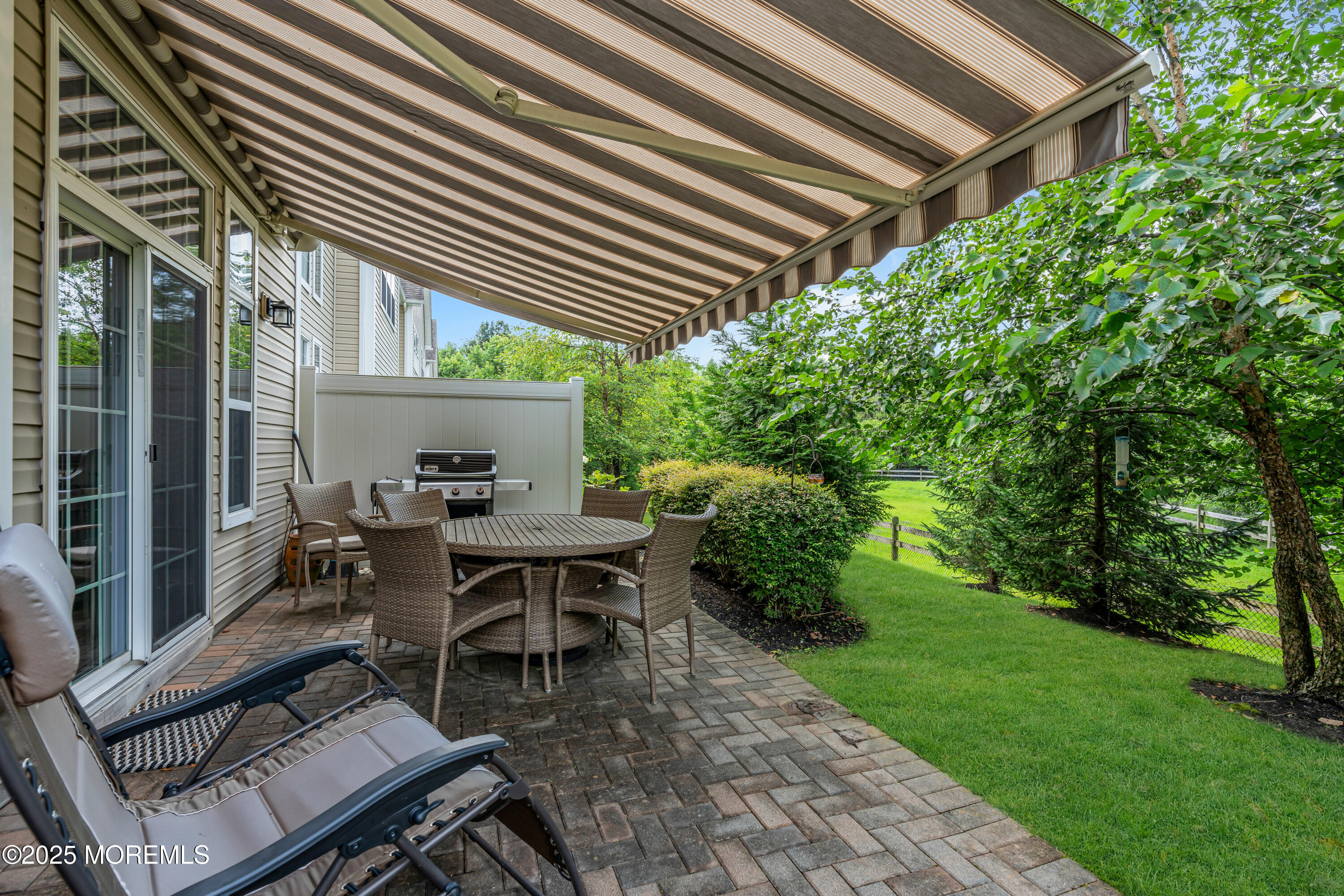 37 Abbey Road Tinton Falls, NJ 07753 - Photo 17 of 18 a backyard of a house with a table and chairs