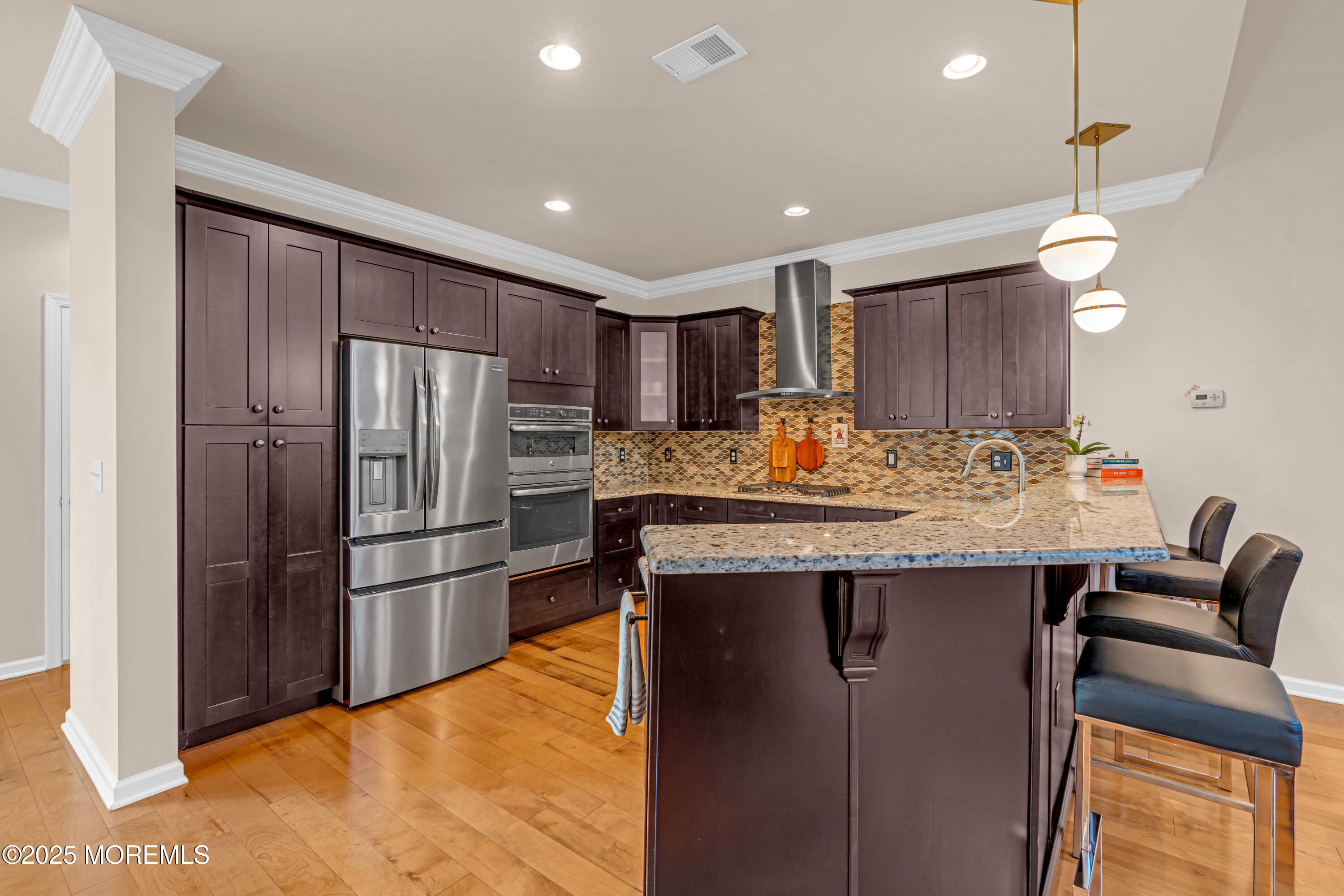 37 Abbey Road Tinton Falls, NJ 07753 - Photo 4 of 18 a kitchen with stainless steel appliances granite countertop a refrigerator and a stove top oven