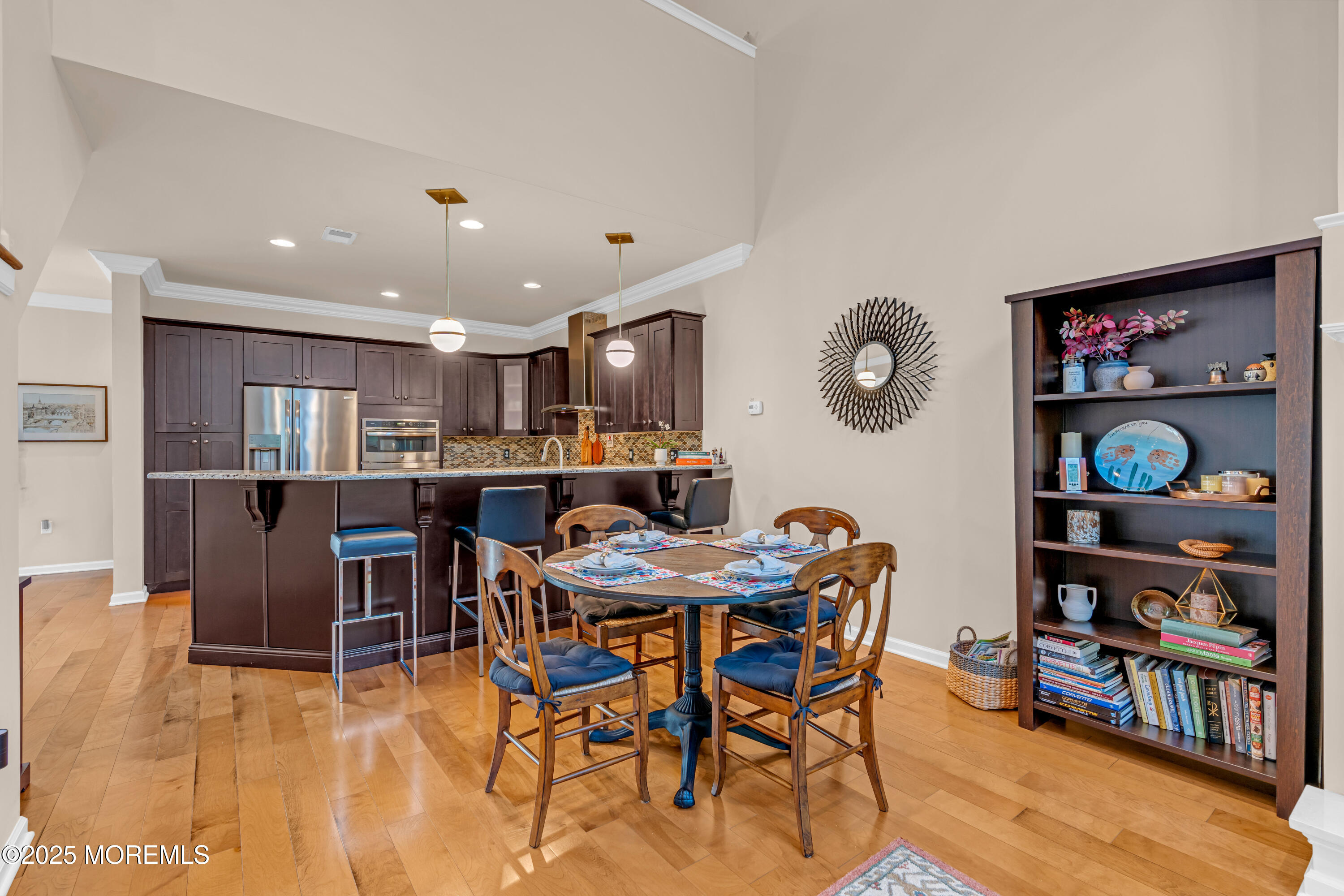 37 Abbey Road Tinton Falls, NJ 07753 - Photo 5 of 18 a view of a dining room with furniture and a bookshelf