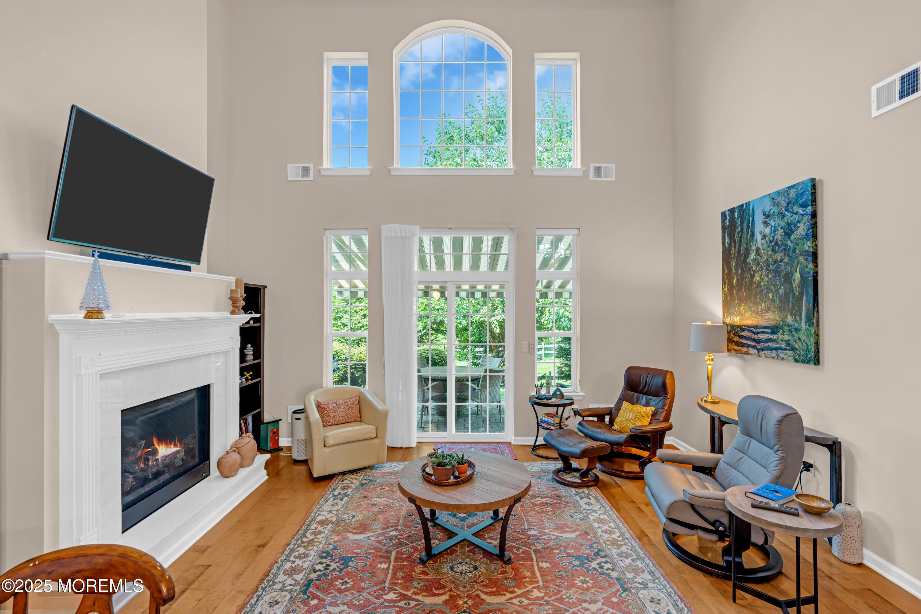 37 Abbey Road Tinton Falls, NJ 07753 - Photo 6 of 18 a living room with furniture a fireplace and a flat screen tv