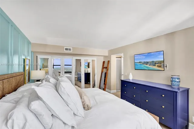 a bed room with a bed and a mirror