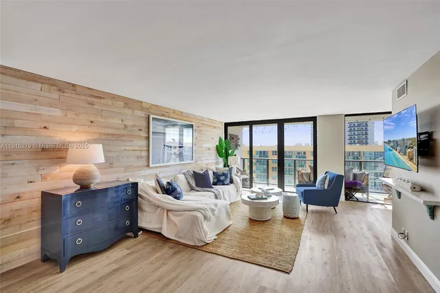 a living room with furniture and large windows