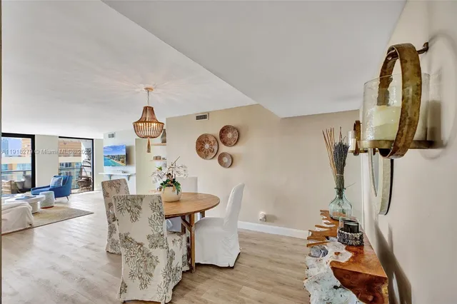 a dining room with furniture and a wooden floor