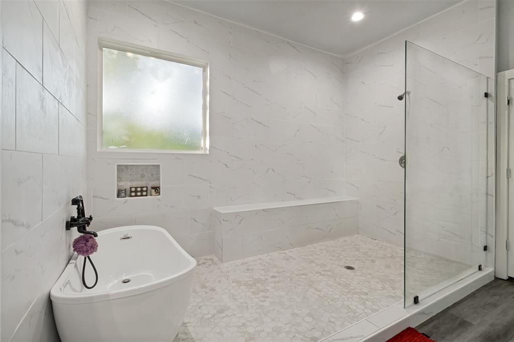 7909 Ivory Lane Dallas, TX 75216 - Photo 14 of 20 a bathroom with a bathtub and shower