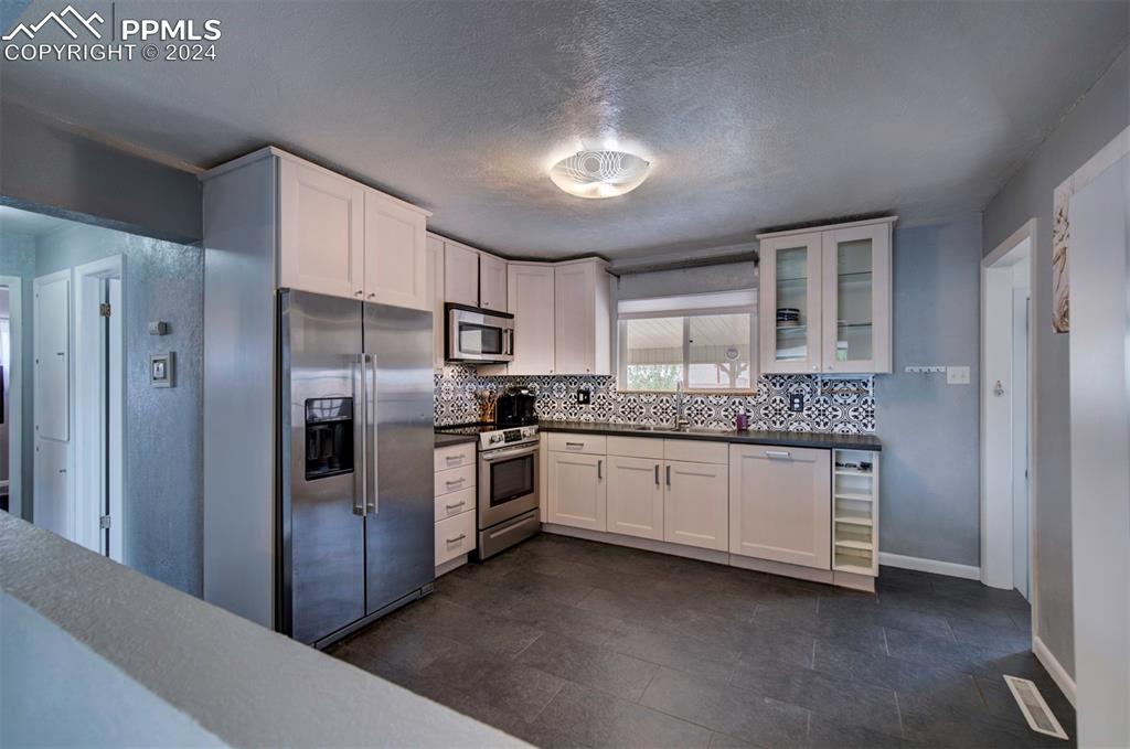 50 Duke Street Pueblo, CO 81005 - Photo 11 of 45 a kitchen with granite countertop stainless steel appliances a sink and cabinets