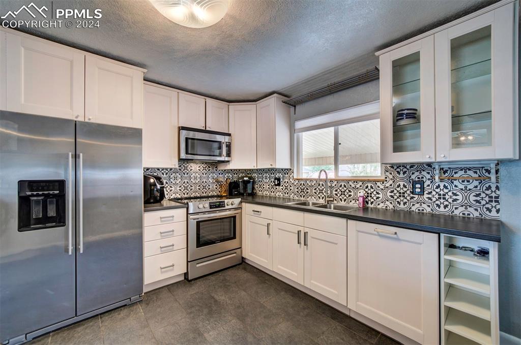 50 Duke Street Pueblo, CO 81005 - Photo 19 of 45 a kitchen with granite countertop white cabinets stainless steel appliances and a counter space