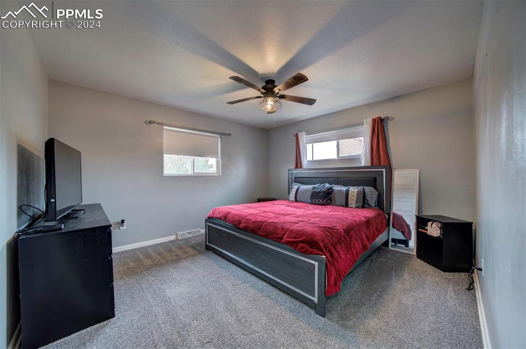 50 Duke Street Pueblo, CO 81005 - Photo 24 of 45 a bedroom with a bed and a flat tv screen on the dresser