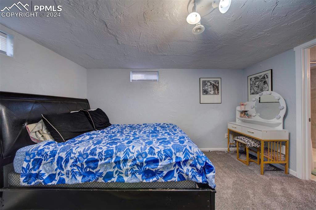 50 Duke Street Pueblo, CO 81005 - Photo 35 of 45 a bedroom with a bed and a lamp on dresser