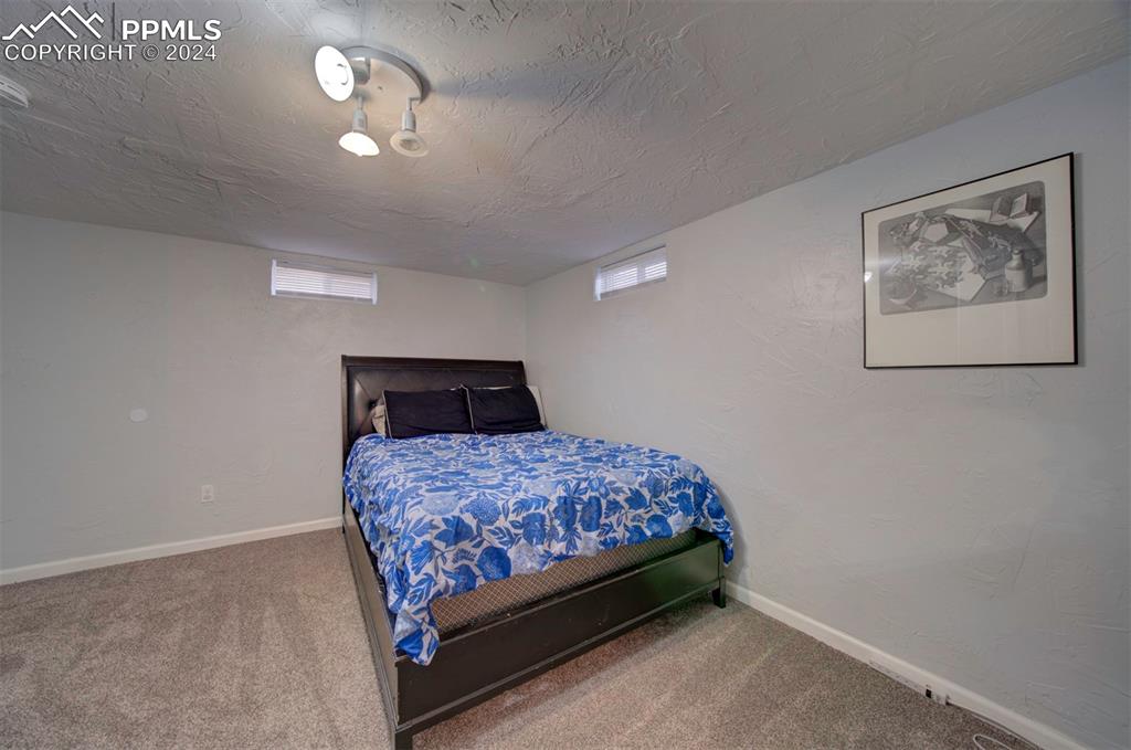 50 Duke Street Pueblo, CO 81005 - Photo 36 of 45 a bedroom with a bed and a chandelier