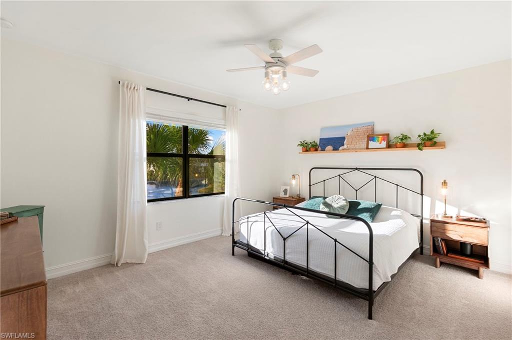 7421 Rockefeller Drive Naples, FL 34119 - Photo 14 of 37 a bedroom with a bed and a window