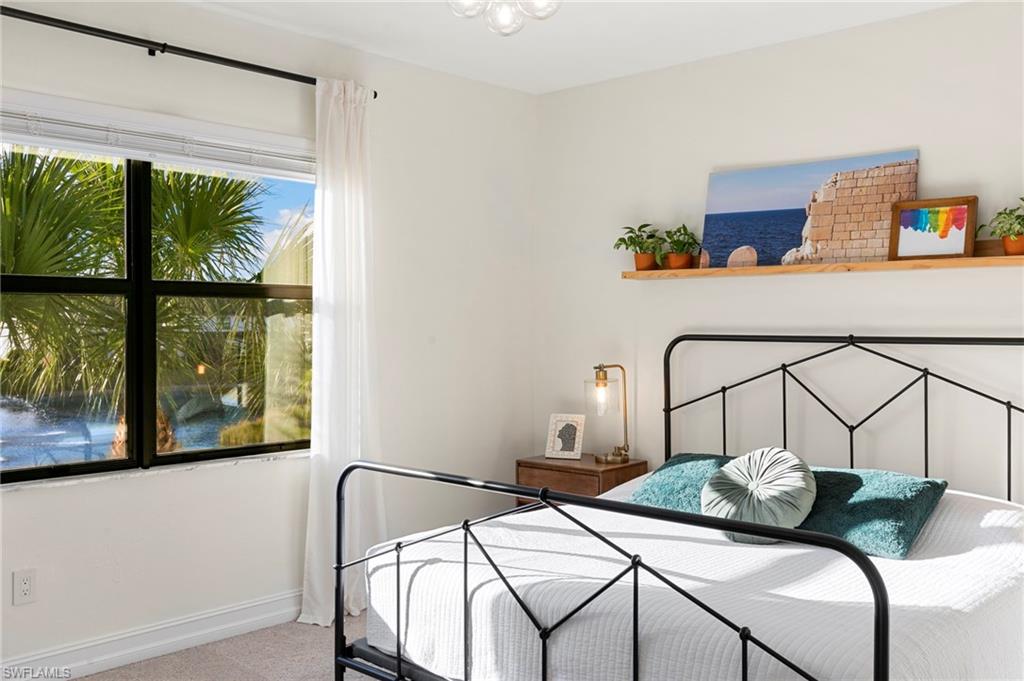 7421 Rockefeller Drive Naples, FL 34119 - Photo 15 of 37 a bedroom with two bed and a window