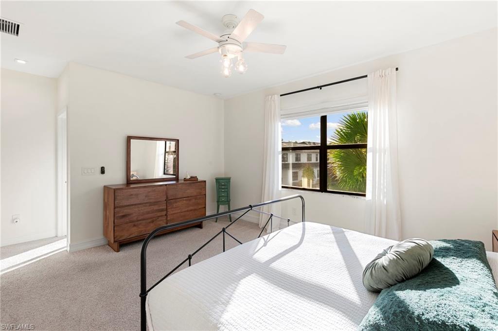 7421 Rockefeller Drive Naples, FL 34119 - Photo 16 of 37 a bedroom with a bed and a window