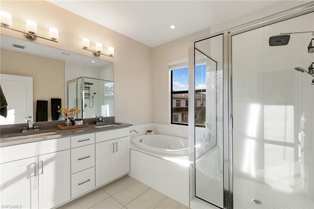 7421 Rockefeller Drive Naples, FL 34119 - Photo 17 of 37 a bathroom with a granite countertop sink mirror and double