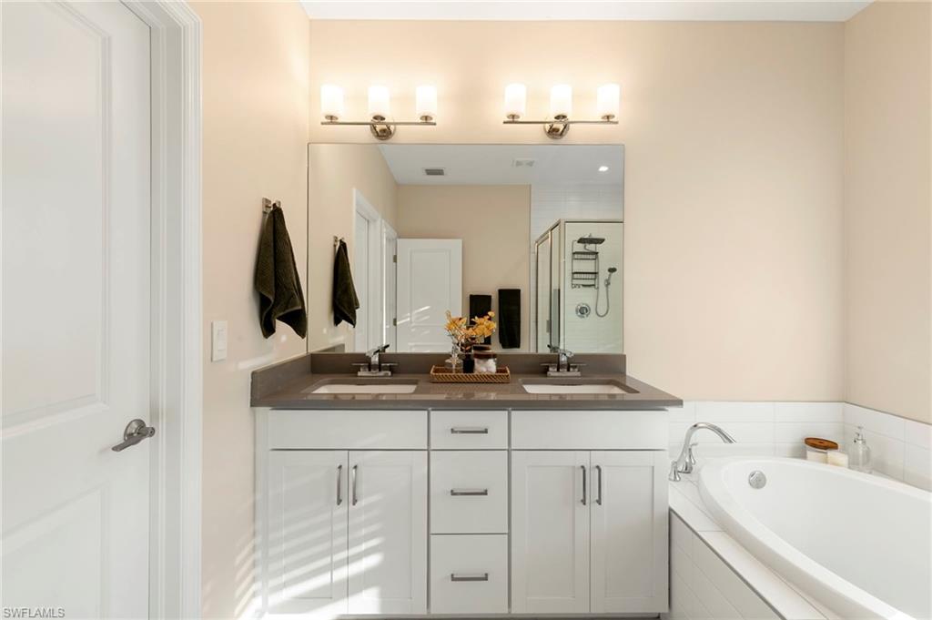 7421 Rockefeller Drive Naples, FL 34119 - Photo 18 of 37 a bathroom with a sink and a mirror
