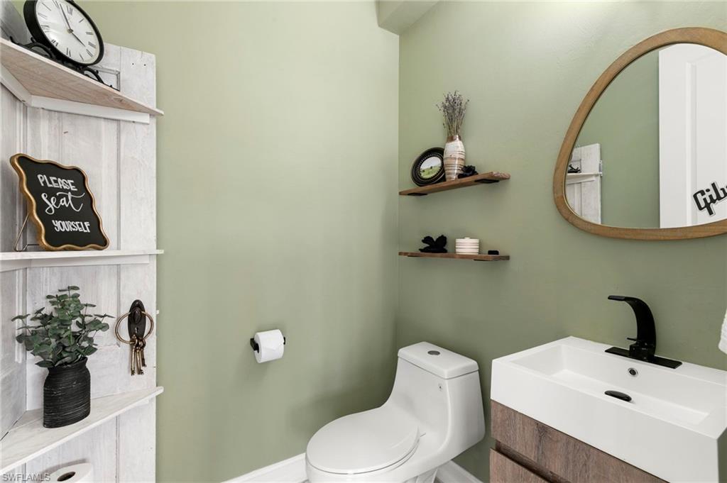 7421 Rockefeller Drive Naples, FL 34119 - Photo 24 of 37 a bathroom with a sink mirror and toilet