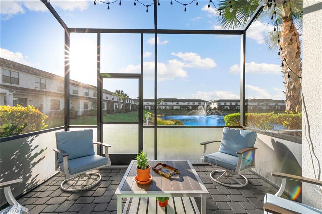 7421 Rockefeller Drive Naples, FL 34119 - Photo 27 of 37 a balcony view with a couch and large windows