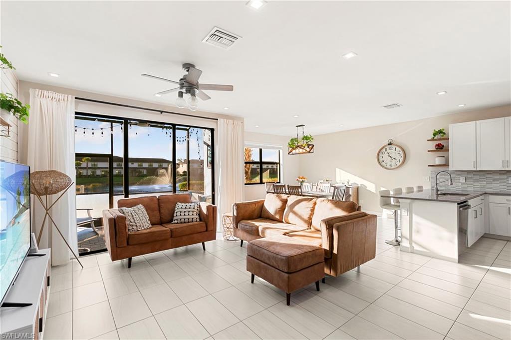 7421 Rockefeller Drive Naples, FL 34119 - Photo 3 of 37 a living room with furniture and a large window