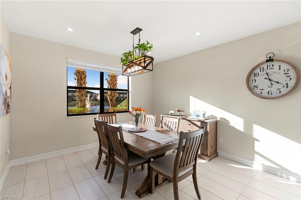 7421 Rockefeller Drive Naples, FL 34119 - Photo 6 of 37 a view of a dining room with furniture and chandelier