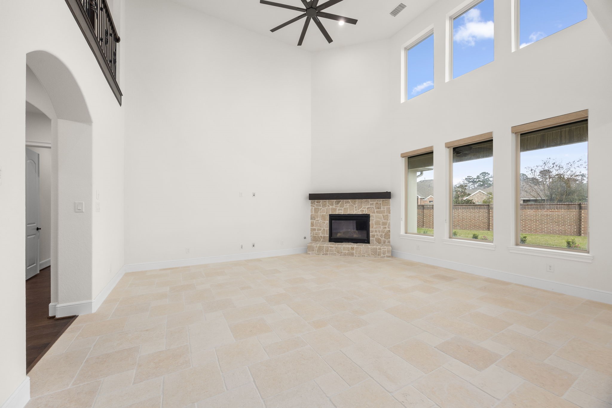 8551 Tombron Grove Road Magnolia, TX 77354 - Photo 20 of 49 Rustic limestone flooring with an impressive stone fireplace serves as a focal point which blends rustic charm with refined elegance creating an inviting environment for relaxing evenings.