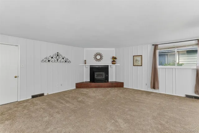 a view of an empty room with a fireplace