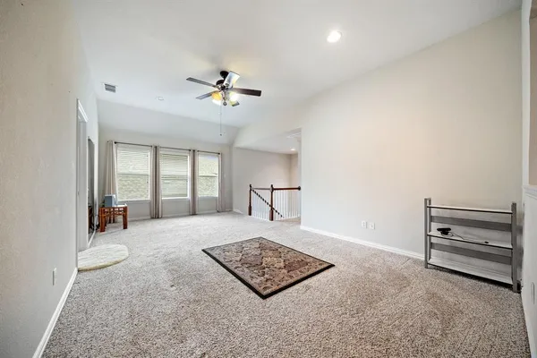 a living room with furniture a ceiling fan and a window