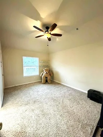 a bedroom with a bed and a chandelier fan