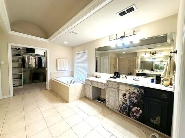 a bathroom with a double vanity sink mirror and shower