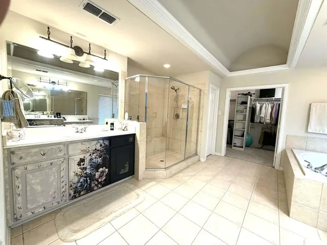 a large white bathroom with a granite countertop sink mirror and bathtub