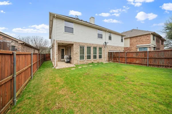 a view of a backyard with a garden and entertaining space