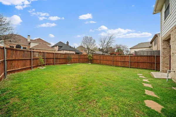 a view of a house with a yard and garage