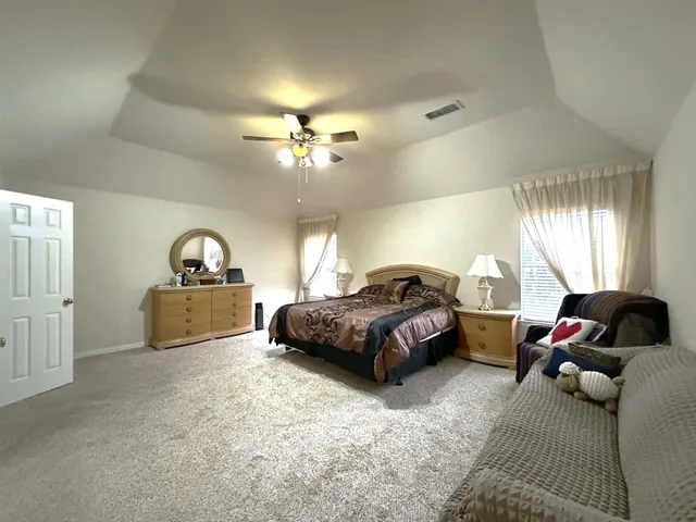 a view of a house with a yard and a patio