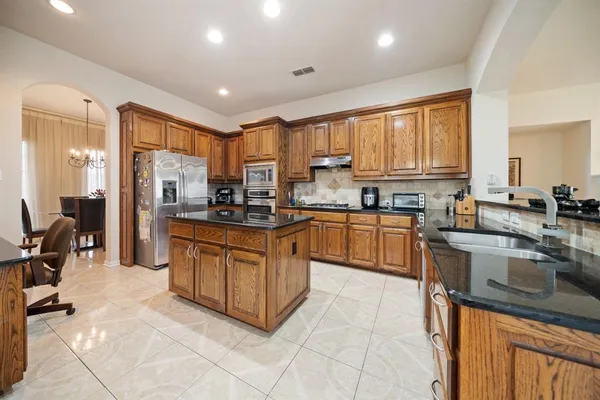 a kitchen with stainless steel appliances a refrigerator and cabinets