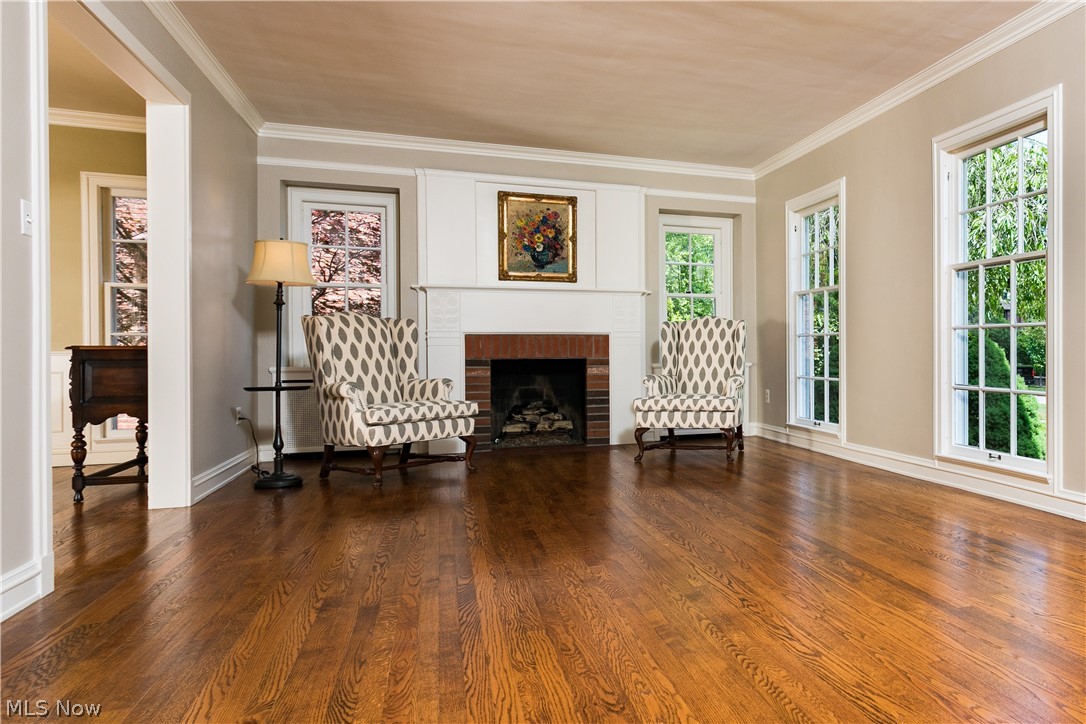 3622 Sutherland Road Shaker Heights, OH 44122 - Photo 3 of 21 In this view of the Living Room, the floor to ceiling windows can be seen along with the gas Fireplace with brick surround and carved Mantel.