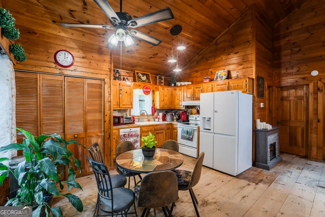 a kitchen with sink refrigerator and stove