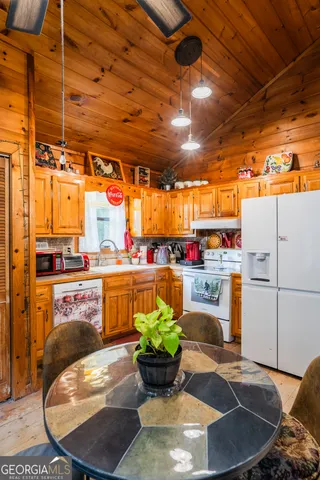 a kitchen with kitchen island granite countertop a sink a counter space and cabinets