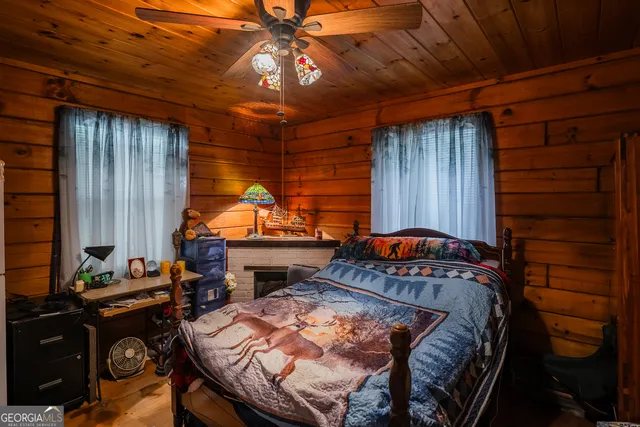 a view of a wooden house with a yard