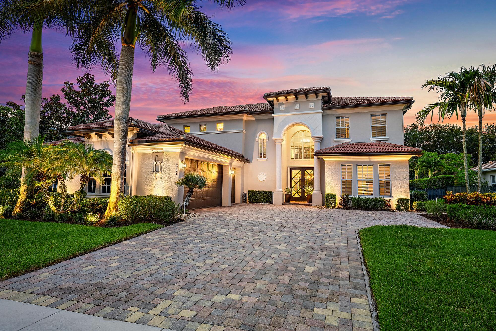 283 Rudder Cay Way Jupiter, FL 33458 - Photo 1 of 41 a front view of a house with a garden and plants