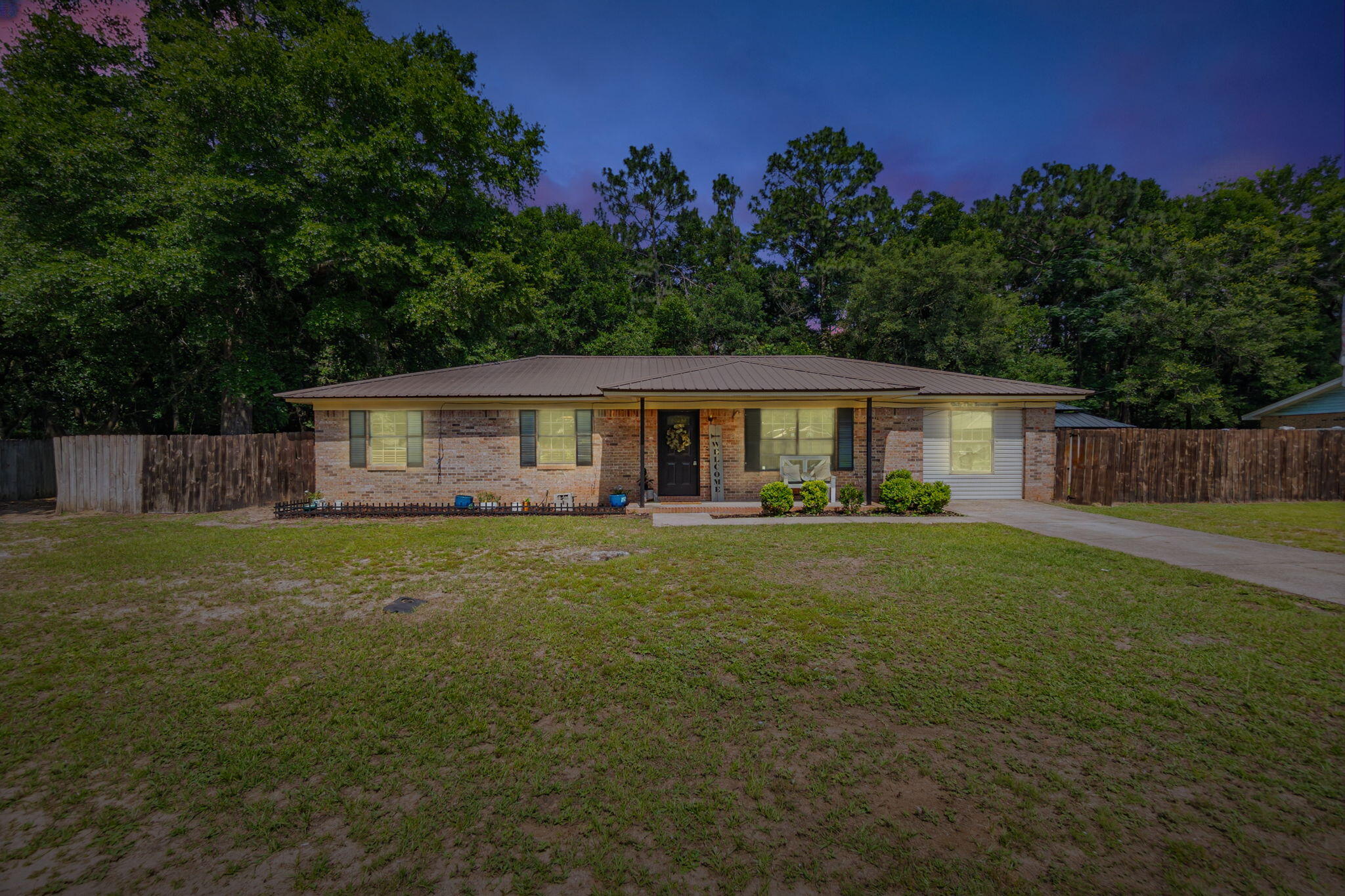 6517 Kennington Circle Milton, FL 32570 - Photo 1 of 37 a front view of a house with a garden