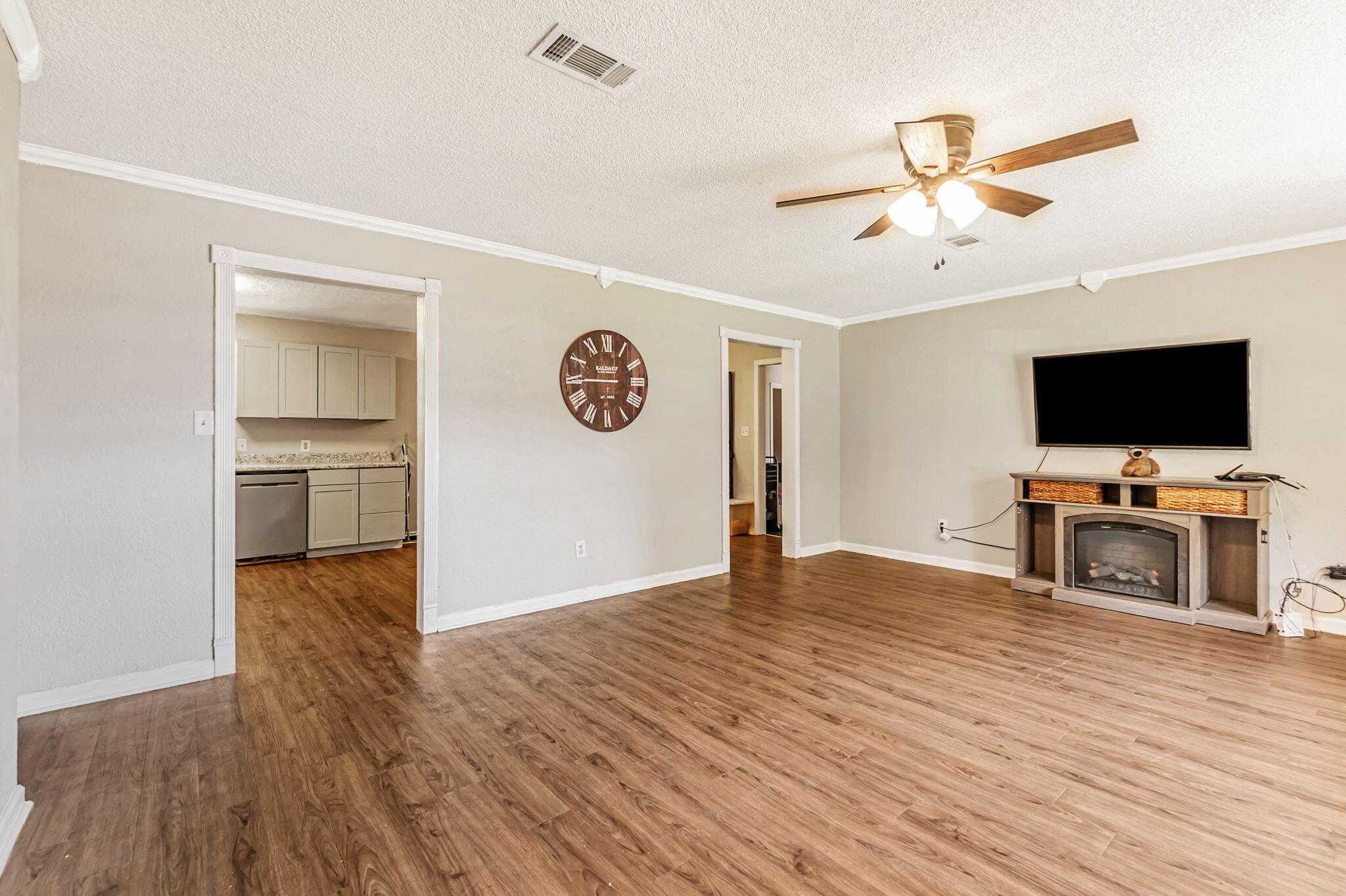 6517 Kennington Circle Milton, FL 32570 - Photo 11 of 37 a view of a livingroom with wooden floor and a flat screen tv