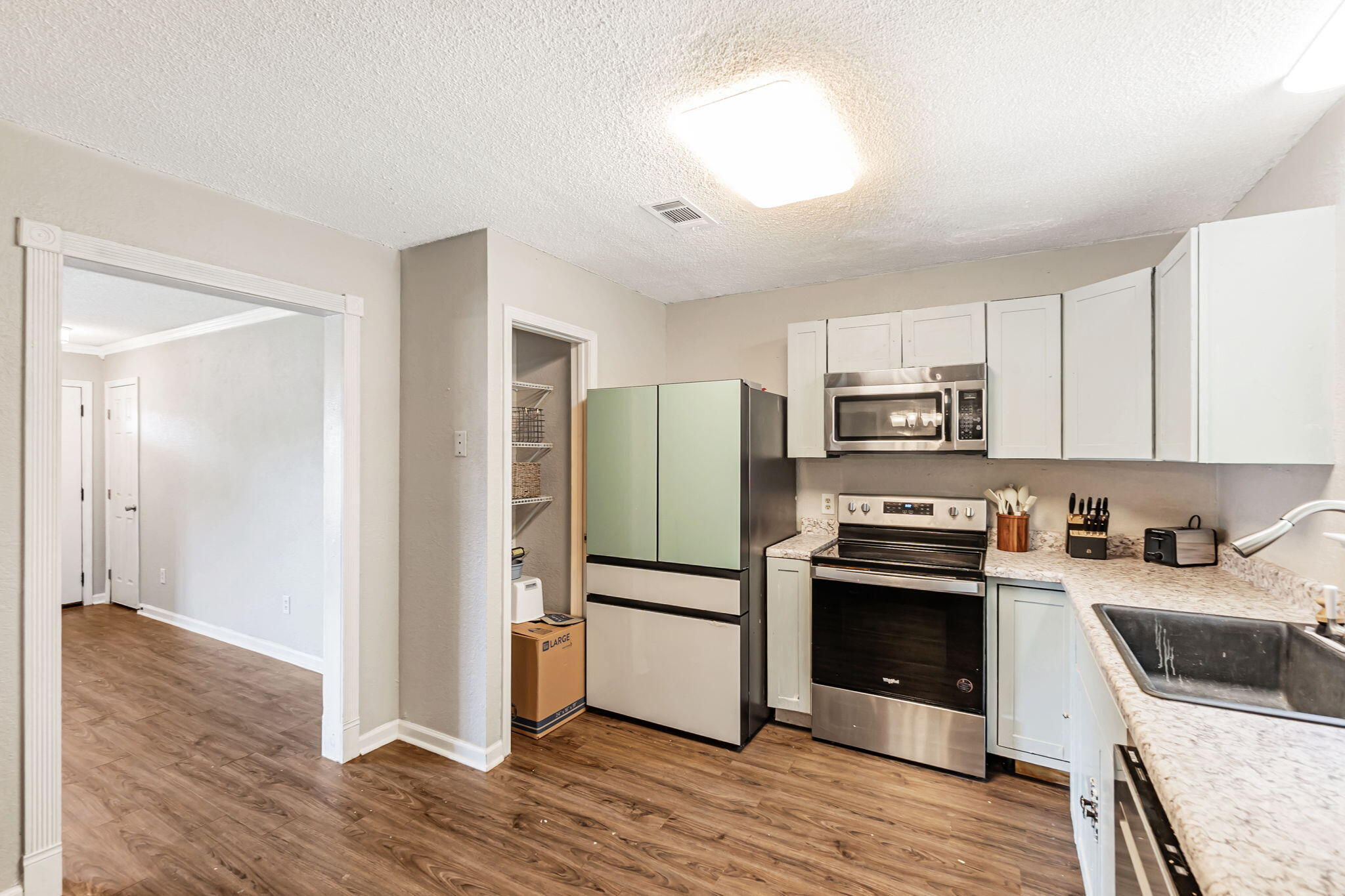 6517 Kennington Circle Milton, FL 32570 - Photo 13 of 37 a kitchen with stainless steel appliances granite countertop a refrigerator stove and sink