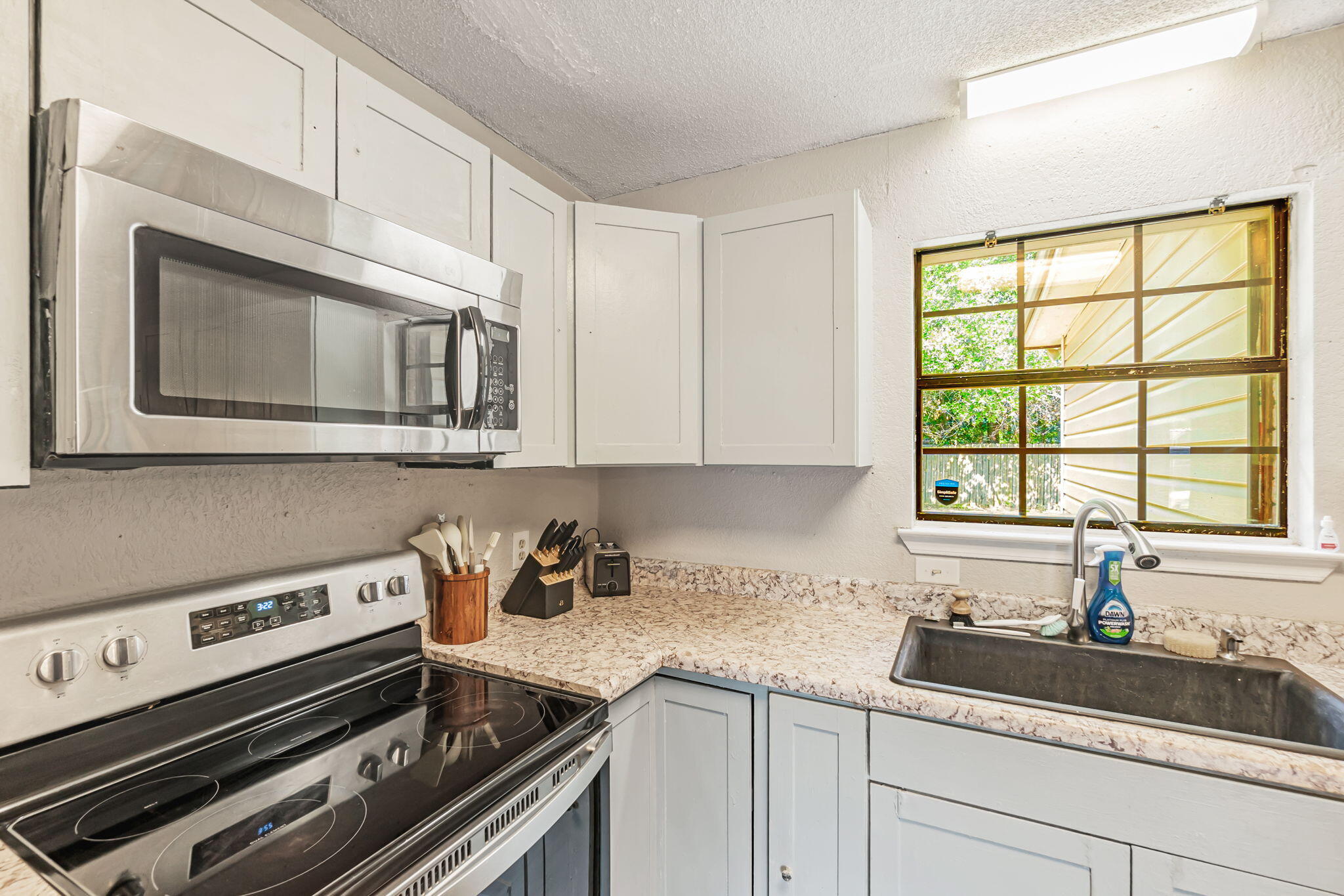 6517 Kennington Circle Milton, FL 32570 - Photo 14 of 37 a kitchen with appliances cabinets and a window